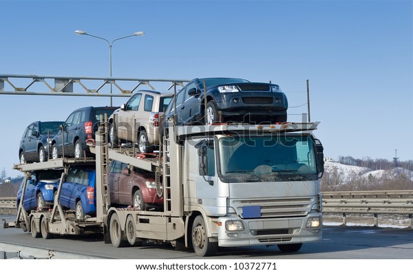  car carrier truck deliver new auto batch to\
dealer  - See similar images of this \
