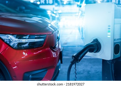 Car Charging At Electric Car Charging Station. Electric Vehicle Charger Station For Charge EV Battery. Charging Point At Car Parking Lot. Clean And Sustainable Energy. Commercial EV Charging Point.