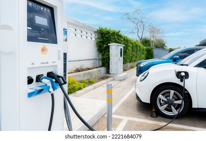 Car Charging At Electric Car Charging Station. Electric Vehicle Charger. Charging Point At Car Parking Lot. Sustainable Energy. Commercial EV Charging Point. AC, CHAdeMO, And CCS2 Or DC Charger Type.