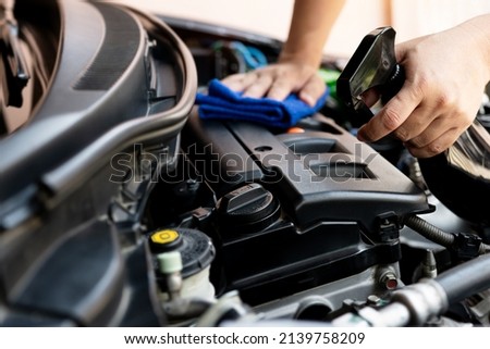 Car clean concept, Hand a man holding clean spray cleaner and microfiber cleaning engine room of car after car wash for the cleanliness and maintenance of the car 