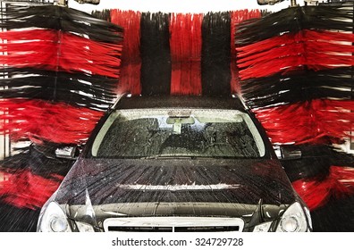A car is cleaned in a Gantry car wash.