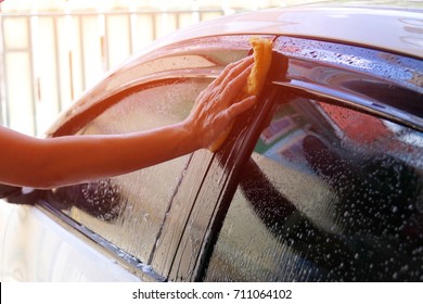 Car Cleaner : Female Hand Holding A Yellow Sponge Car Wash : Clean Car Door Cleaning Concept.