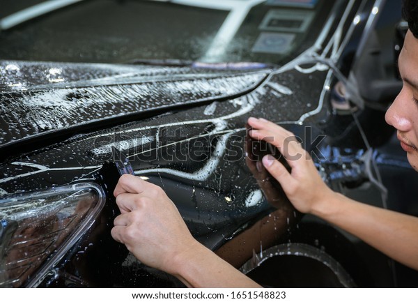 Car cleaning auto\
service : the man cleaning and polishes. car detailing concepts.\
Selective focused