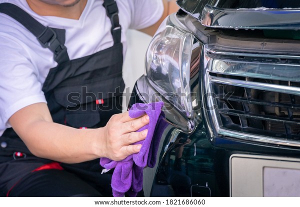 Car cleaning auto\
service : the man cleaning and polishes. car detailing concepts.\
Selective focused