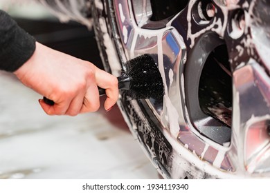 Car Cleaning Cast Silver Car Rims Using A Brush