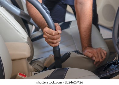 Car Cleaning Details - Man Vacuuming In Car Cabin Professional Car Interior Upholstery Vacuum Cleaner For Dirty Car Interiors.