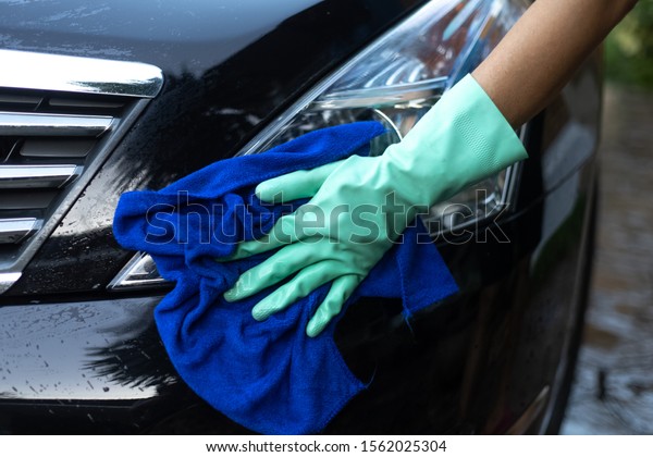 Car
cleaning.
The hand of a man using a car
towel.