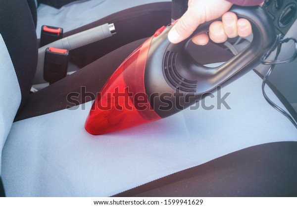 Car cleaning with\
handheld vacuum cleaner\
