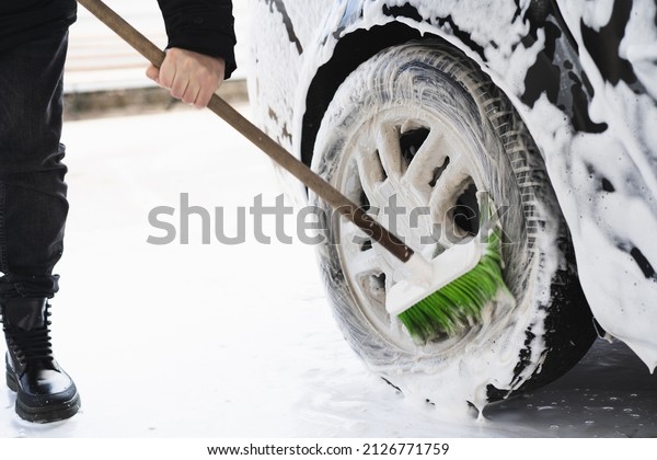  Car cleaning service. The man washing\
his car on self-service car. Express Car\
Wash