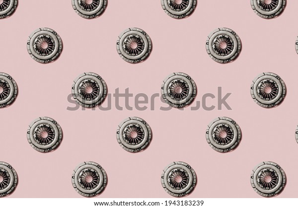 Car clutch disc on a pink background. Auto\
parts. Pattern.