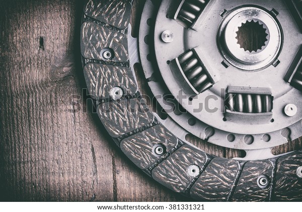 car clutch disk on wooden table - toned\
image, retro film filtered in instagram\
style