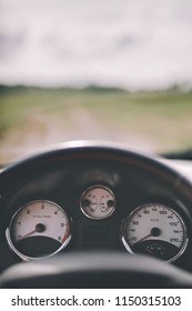 Car Cockpit And A Dirt Road In The Field. First Person Perspective. Road Trip. Travelling.