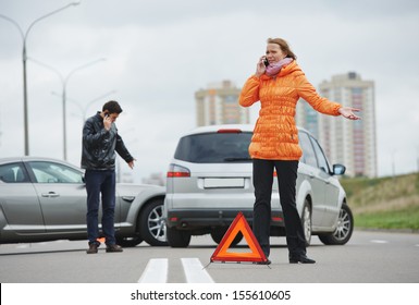 Car Collision. Driver Man And Woman Examining Damaged Automobile Cars After Crash Accident In City