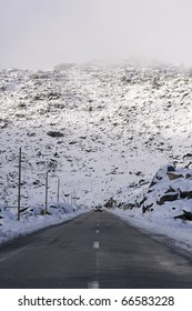 Car coming down from the mountain avoiding the storm