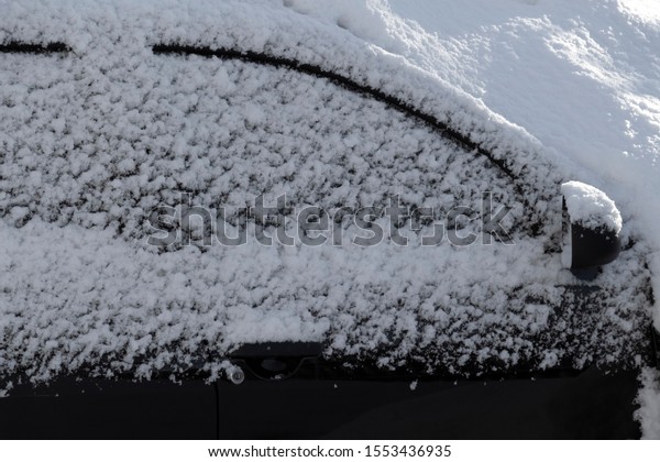 The\
car was completely covered with snow in the\
backyard.
