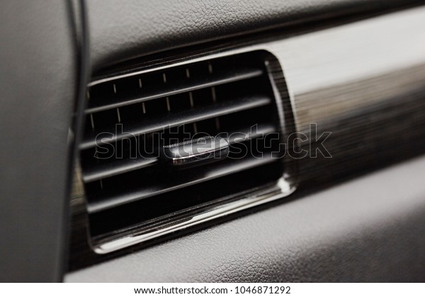Car conditioner. The\
air flow inside the car. Detail interior. Air ducts, deflectors on\
the car panel