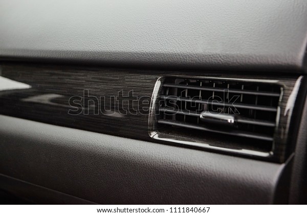 Car conditioner. The
air flow inside the car. Detail interior. Air ducts, deflectors on
the car panel
