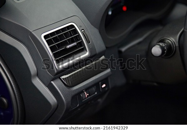 Car conditioner. The air flow inside the car.\
Detail interior. Air ducts, deflectors on the car panel. Vehicle\
control buttons