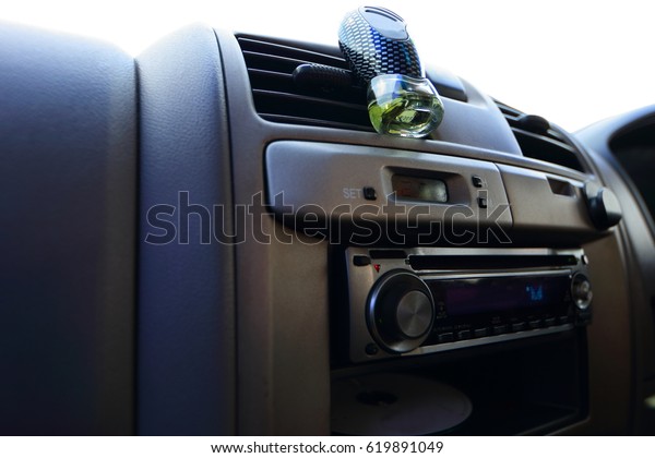 Car console and accessory\
on dashboard, perfume, small bag for put trivial things, air\
conditioner