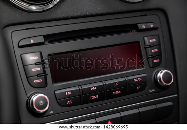 Car control panel of audio player and other\
devices.A shallow depth of field close up of the control panel of a\
car. Parts shown are the CD player and radio controller, as well as\
the air conditioning