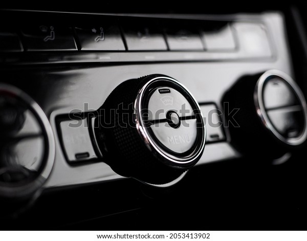 car control panel buttons and climate\
inside a new modern car. stove and air conditioning, climate\
control works. stylish salon. shallow depth of\
field