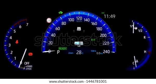 Car\
counter in hybrid vehicle. Instrument panel with display indicating\
battery charge level, speedometer, tachometer, odometer, fuel gauge\
and oil temperature gauge. Blue illuminated\
display.