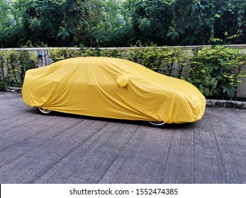 Car cover care on white background.  car is covered with a car protective awning on a white background. Insulated object. Protects the vehicle's paintwork. Protects the vehicle from the sun