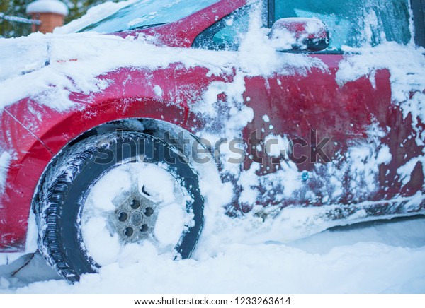 Car covered with fresh white snow,  car under\
the snow, after the\
snowfall.