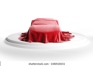  Car covered with red silk cloth on a white podium. Isolated with clipping path.