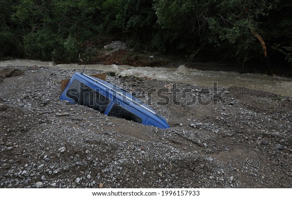 A car covered up as a result of overflowing\
the banks of the river after a heavy downpour in the city of Yalta\
(Crimea, Crimean peninsula).