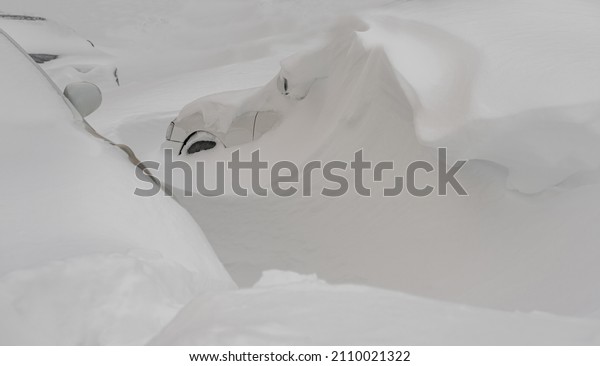 car covered with snow\
after a heavy snow storm.Vehicles are covered with snow during a\
heavy snowfall.