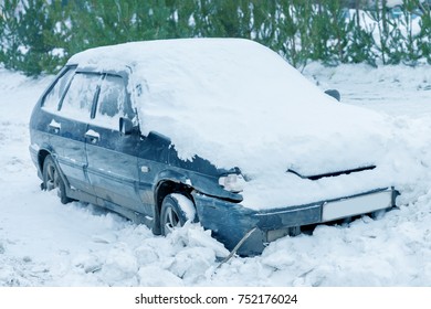 Car covered with snow in blizzard