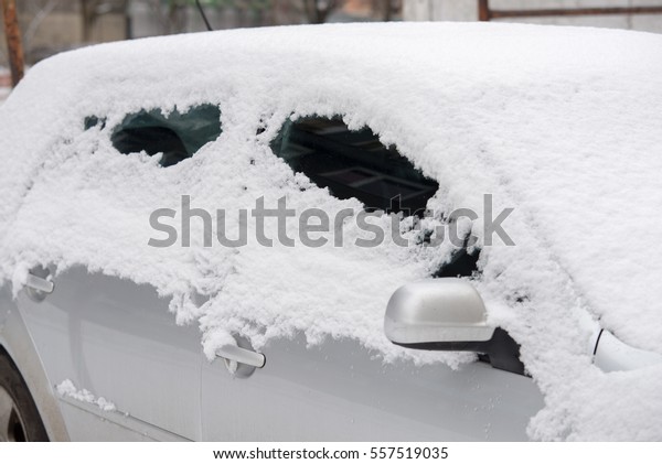 car covered with snow in\
the city