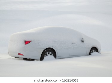 Car Covered With Snow In The Forest