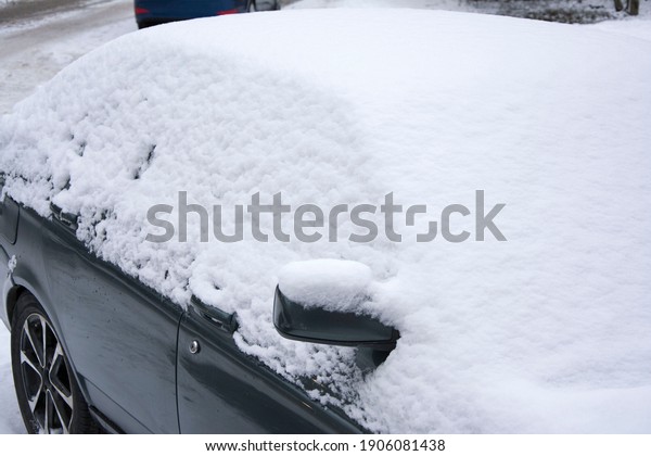 car covered with snow, roof and glass\
and hood under a layer of snow, you need to\
clean