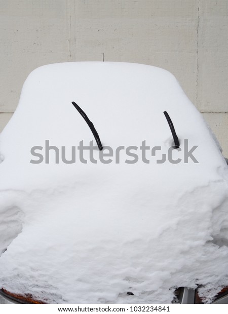 Car covered with snow in\
the winter