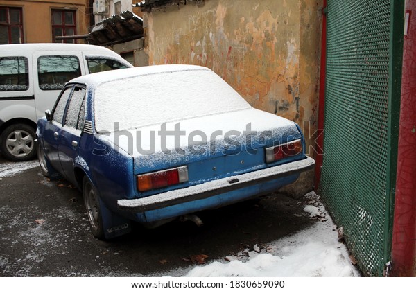 car covered with snow in\
the yard