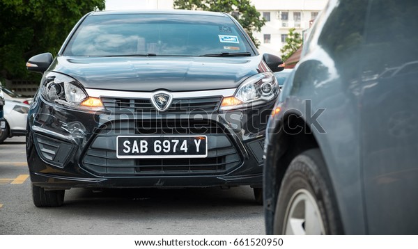 Car crash accident on the street - 9 june, 2017 Kota\
Kinabalu, Malaysia. Selective focus on the damaged automobile with\
scratches and broken headlight. Crashed stoplight on the dark\
car