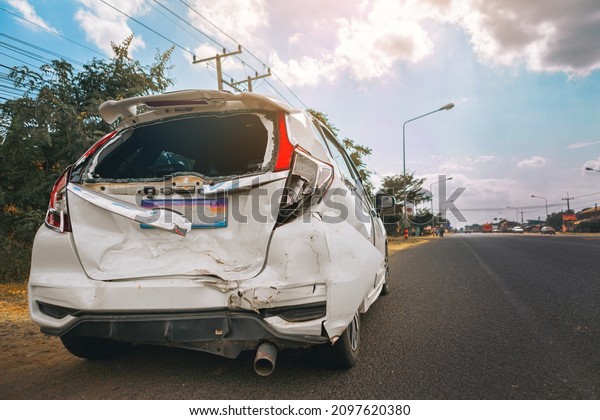 Car crash\
dangerous accident on the road. A car crashing damaged by another\
one on the road waiting for\
rescue.