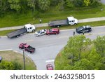 Car crash site with emergency services personnel and vehicles responding to accident on American street. First responders helping victims of vehicle collision on bridge road in USA