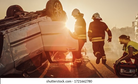 Car Crash Traffic Accident: Paramedics and Firefighters Plan Rescuing Passengers Trapped in Rollover Vehicle. Medics Prepare Stretchers and First Aid Equipment. Firemen Use Hydraulic Cutters Spreader