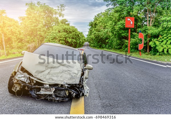 The car crashed down the road, caused by
negligence and emergency phone
background