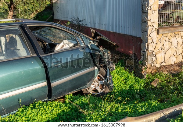 The car crashed into the wall, looking after the\
crash. Drunk driver.