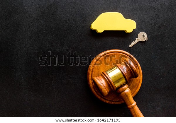 Car credit debt concept with judge gavel on\
black background top-down copy\
space