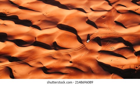 Car crossing the the waves of Oman desert