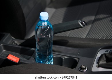 In The Car In The Cup Holder There Is A Bottle Of Water, For The Driver