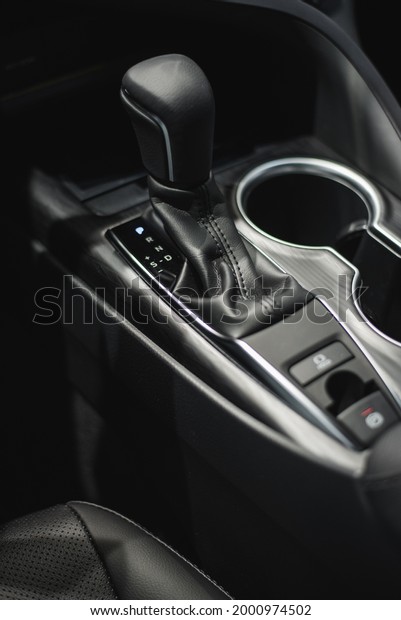 car cup holders between back seats, close up\
view, luxury car interior