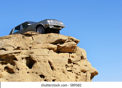 Car Dangerously Close To The Edge Of A Sandstone Cliff