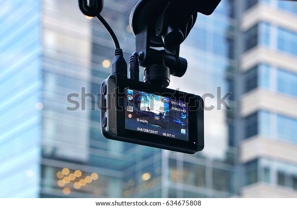 A\
car dash cam mounted on the front windshield recording the traffic\
ahead in case of an emergency situation or an\
accident