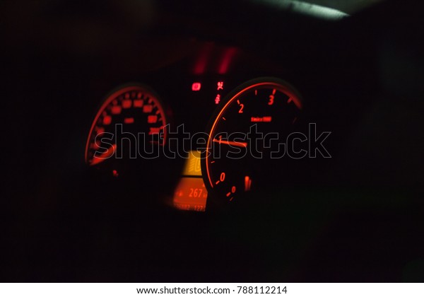 The car dash at night\
lighted orange